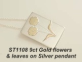 Silver pendant with 9ct gold flowers and leaves.